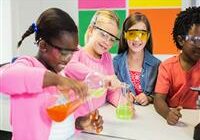 four students participating in science, mixing colorful solutions